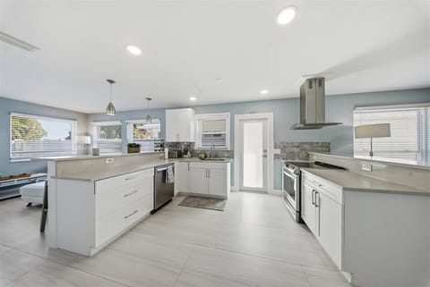 Open kitchen with updated appliances, bar sitting area