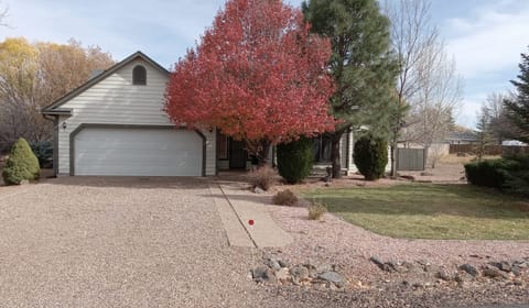 Front of home in Fall. No neighbor to one side nor in back. Safe gated community