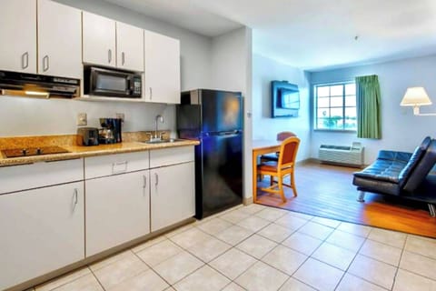 Coffee/tea maker, fridge, microwave, dining table