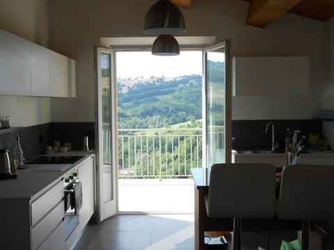 The kitchen is fresh, bright and modern and leads out onto the terrace.