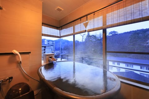 Japanese-Western style room with hot spring bath | Bathroom | Combined shower/tub, free toiletries, hair dryer, slippers