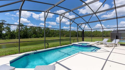Pool with a view! Private oasis backing onto serene retention pond & forest.