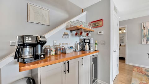 Coffee bar with beverage refrigerator. Coffee and tea provided.