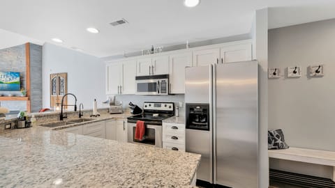 Kitchen with granite counter tops and stainless steel appliances.