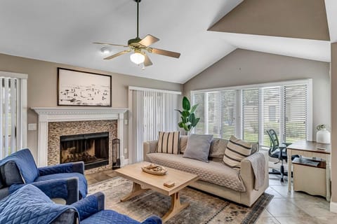- Cozy living room with a work friendly corner desk, ideal for remote work or creative time
- Soaring ceilings, fireplace, and soft sunlight make this a favorite place to unwind
- Mix of comfort and utility with plush seating and modern textures throughout