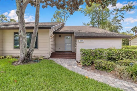 Charming single level villa with private entry and manicured landscaping.