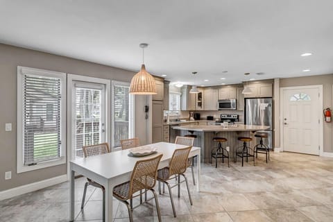 - Bright open concept kitchen and dining area perfect for family style meals and hangouts
- French doors bring in natural light and offer direct access to the outdoor lawn
- Stylish blend of tile flooring, modern finishes, and natural textures throughout