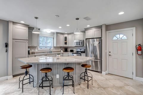 - Large granite island with bar seating for four, ideal for casual dining or morning coffee
- Stainless steel appliances and soft gray cabinetry offer a sleek, cohesive look
- Pendant and recessed lighting brighten every culinary moment