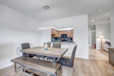 - Stylish dining area with cushioned bench, sleek chairs, and minimalist lighting
- Located just off the kitchen, this space is ideal for group dinners and games
- Warm wood floors and soft tones create a welcoming space for every meal