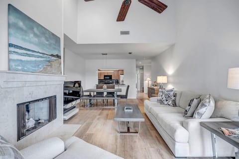 - Relax beneath soaring ceilings and cool breeze from the ceiling fan above
- Two full size sofas offer plenty of seating near the fireplace and smart TV
- Sophisticated layout ensures a spacious yet intimate shared living space