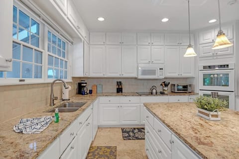 - Elegant granite countertops and crisp white cabinets offer a clean, spacious prep zone
- All major appliances, coffee station, and generous lighting for cooking with ease
- Stylish touches and thoughtful layout make kitchen time feel effortless
