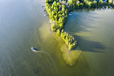 Located on a private peninsula, means 1200 feet of lake frontage and 360 degree views of the water at all times.
