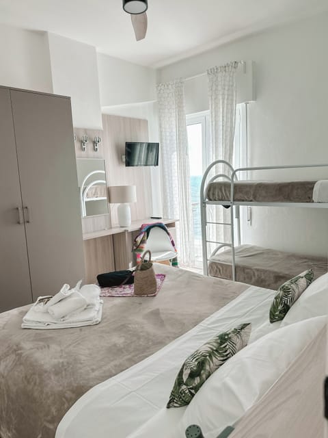 Deluxe Quadruple Room | Premium bedding, in-room safe, blackout drapes, cribs/infant beds