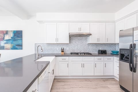 The kitchen comes stocked with dishes, utensils, cookware, bakeware, and major and small appliances.
                