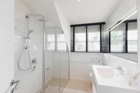 Shower, bathrobes, slippers, towels