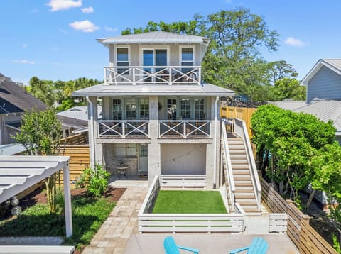 You are located on the second floor entry. Primary on 3rd floor. Charming coastal-style property featuring multiple levels, balconies, and private outdoor space surrounded by mature trees.