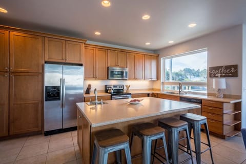 The kitchen island is a great gathering spot while the cook is preparing a feast.