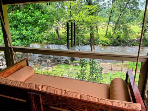 Relax, Rest, Rejuvenate on the couch swing as you listen to the creek sounds.