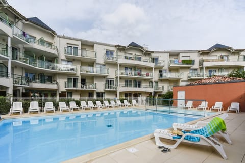 Lounge by the pool in the sunshine.