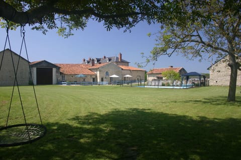 View across the communal gardens to the 3 gites and swimming pool