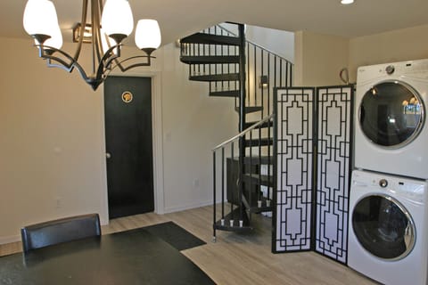 Black entry door to Shroom Suite, staircase up to Perch Suite & Summit Suite