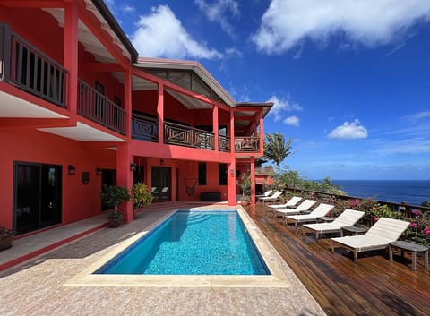Rear of villa, pool deck, salt-sanitized pool over Marigot Bay & Caribbean Sea