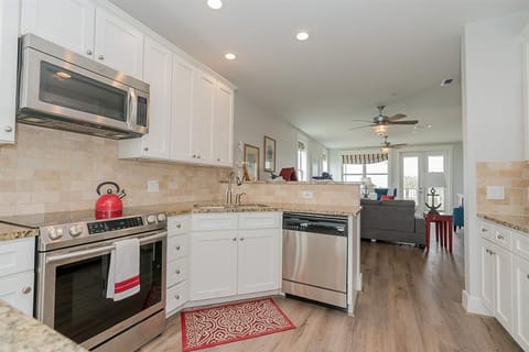 Kitchen looks into living room