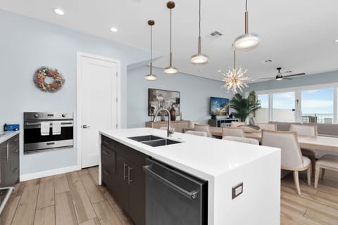 Fully stocked kitchen equipped with stainless steel appliances and a large center island