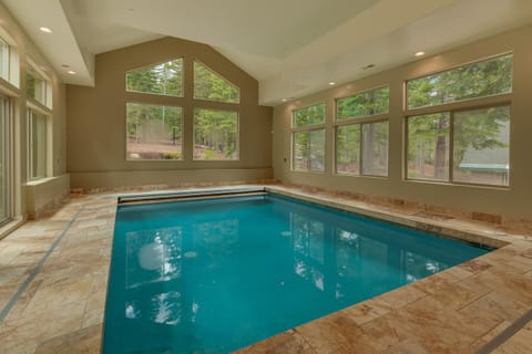 - Indoor swimming pool with forest views through large windows  
- Relax in year-round comfort with natural light streaming in  
- Perfect family-friendly feature for your mountain getaway