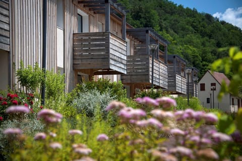 Relax on your private balcony, framed by lush greenery and blooming flowers, for a perfect escape.