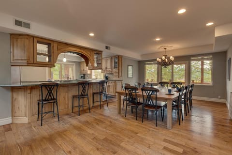 - Spacious dining area with seating for ten  
- Rustic wood table and chandelier lighting  
- Perfect family dining in mountain getaway