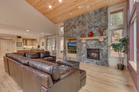 - Open concept living with stone fireplace feature  
- Leather sectional perfect for family gatherings  
- Tahoe rental home with warm rustic mountain charm