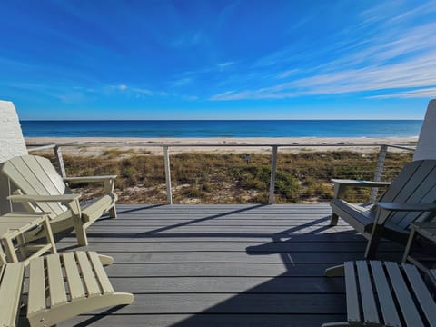 Beachfront deck off Living Room, furnished with 4 Adirondack chairs