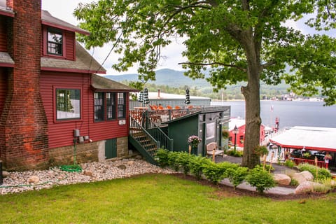 Large outdoor deck overlooking the lake with an enclosed porch