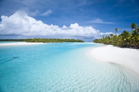 On the beach, white sand, sun loungers, beach towels