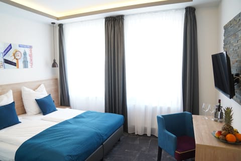 Double or Twin Room | Down comforters, desk, laptop workspace, blackout drapes