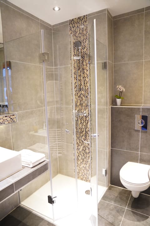 Shower, hair dryer, towels, shampoo