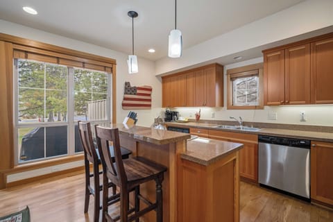 Gather around your spacious kitchen island with rich wood cabinetry, granite counters, and stainless appliances - perfect for cooking memorable meals together.