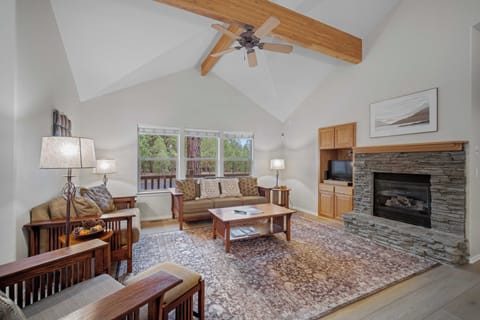 Unwind in your spacious living room with vaulted ceilings, exposed beams, and a cozy stone fireplace perfect for relaxing evenings.