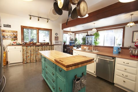 Kitchen from door, coffee area on the left and pantry is behind curtains