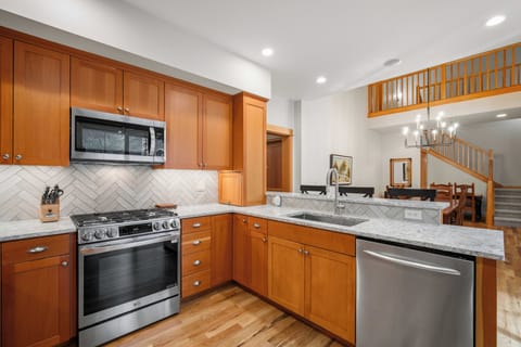 Your fully-equipped kitchen features granite countertops, stainless steel appliances, and warm wood cabinetry—perfect for preparing memorable meals during your stay.