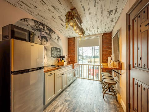 Compact kitchen w/ stainless appliances, open shelving &amp; a cozy breakfast nook by the window