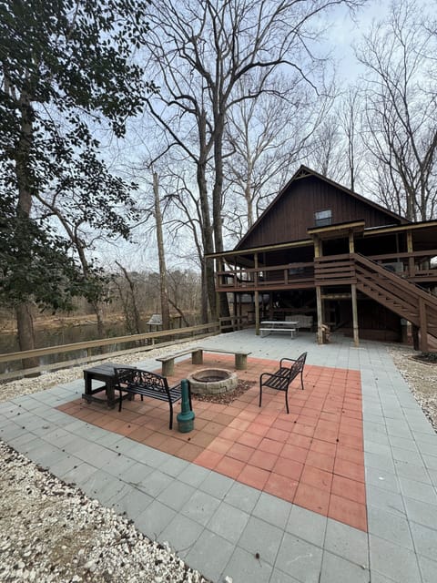 Enjoy the fire pit and patio while watching the river flow by