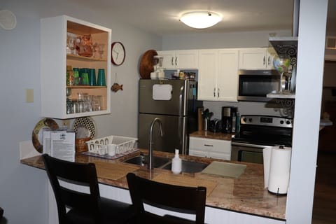 Fully stocked kitchen  with glasses and dish ware for 5 people.