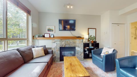 Open living area with Smart TV and fireplace, perfect for relaxing with family or friends