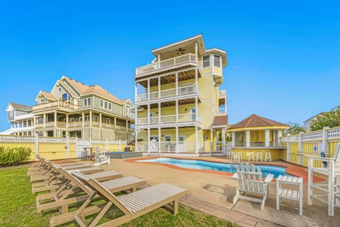 Coastal vacation home with private pool, multiple balconies, and spacious outdoor entertaining areas perfect for beach getaways.