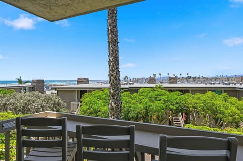 Step out onto your private patio to find a serene outdoor retreat, surrounded by the lush, verdant tropical gardens of North Coast Village, with a beautiful glimpse of the shimmering ocean in the distance.