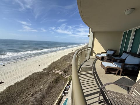 Spacious oceanfront balcony with stunning beach views