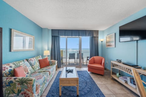 Relax in the comfort of a large well-appointed living room with an ocean view.