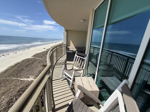 Oceanfront balcony with rocking chairs and stunning beach views